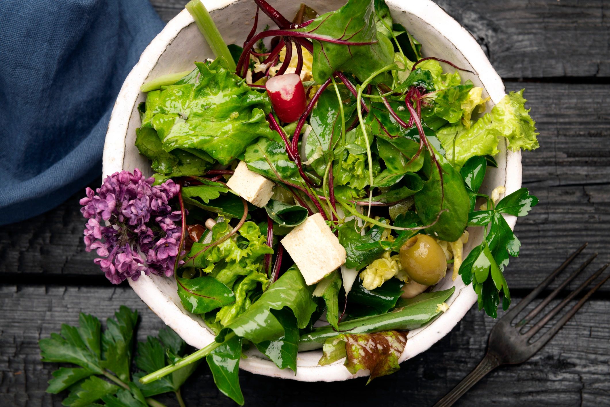 Fresh salad bowl topped with greens